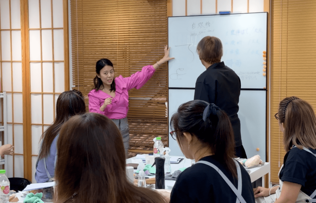 Instructor explaining on whiteboard to students.